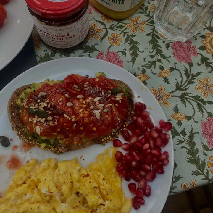 Toast with harissa, scrambled egg and pomegranate seeds