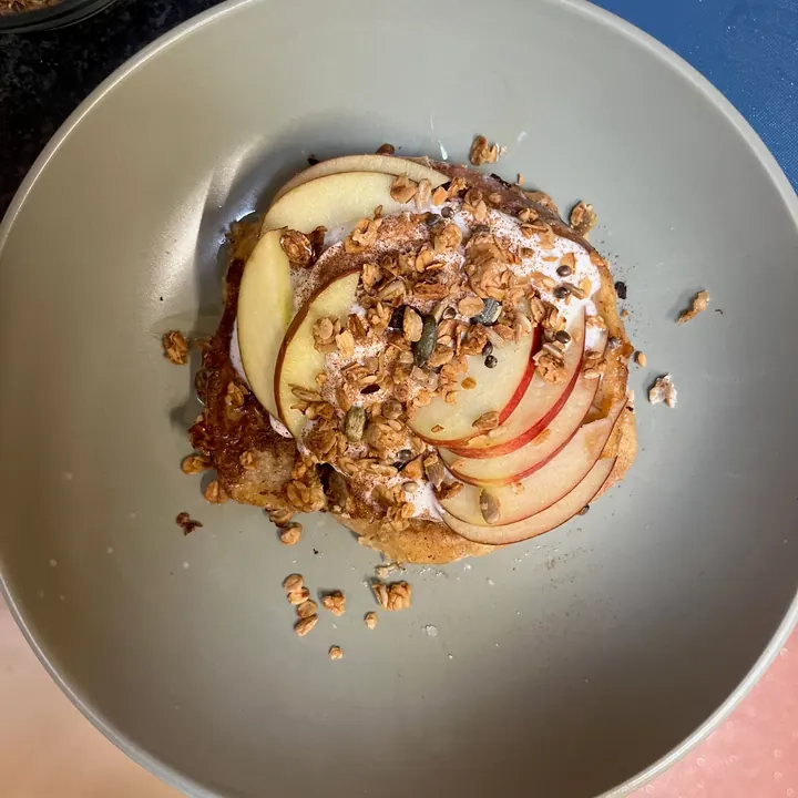 Oat pancakes with apple slices and homemade granola