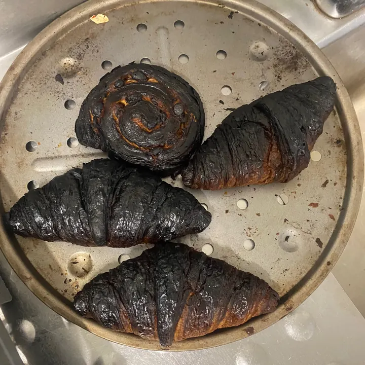 A tray of burnt croissants and pains au chocolat