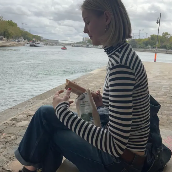 Martha making a sandwich by the Seine in Paris
