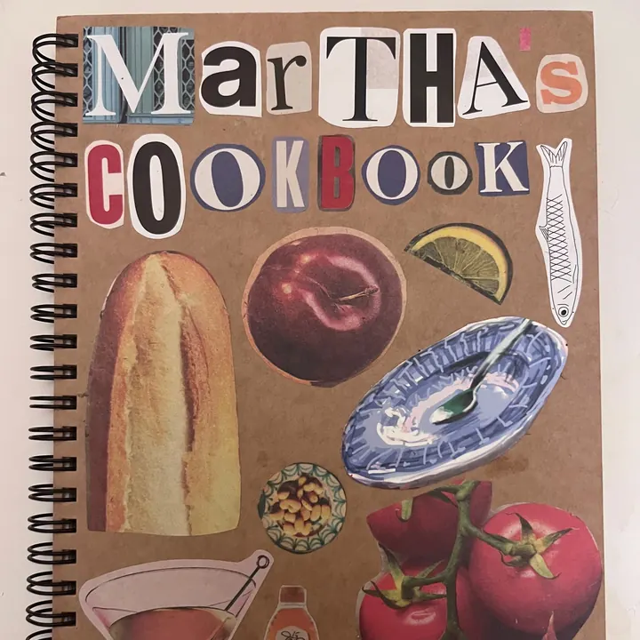 The collaged cover of Martha’s Cookbook, a spiral-bound notebook